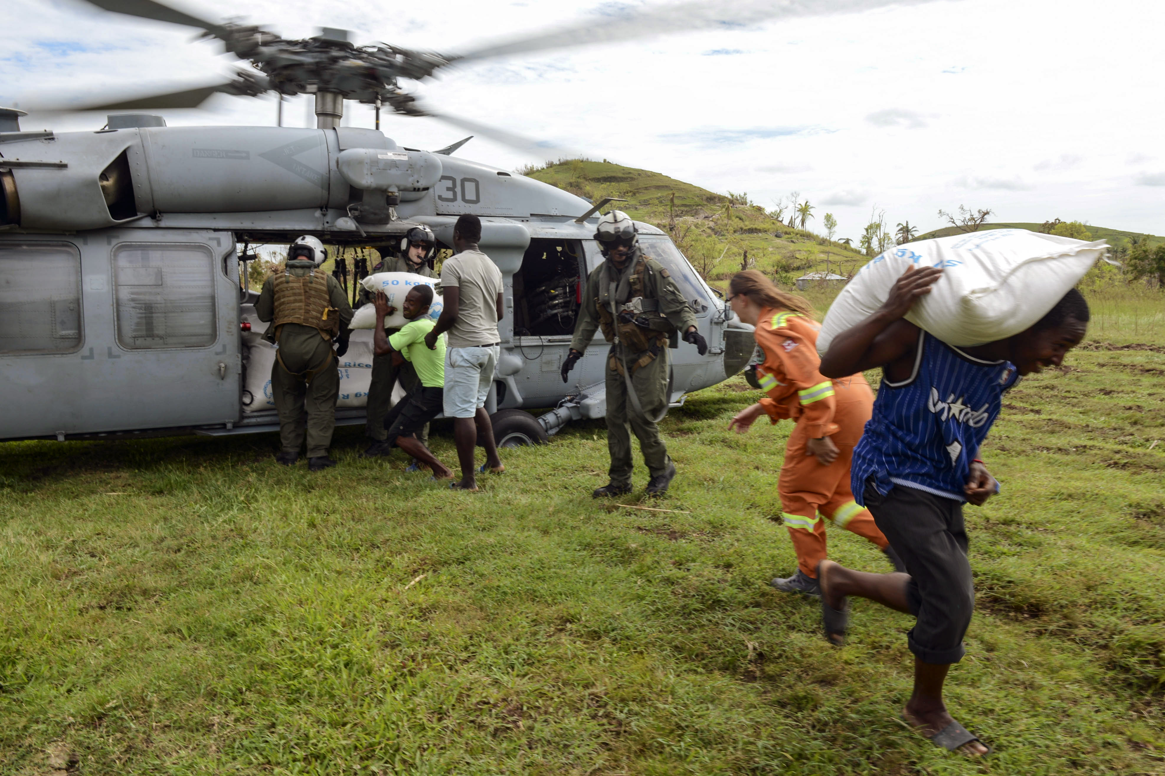 Sailors and Marines attached to Joint Task Force (JTF) Matthew deliver food to the village of Jabouin on Oct. 18. US Navy photo.