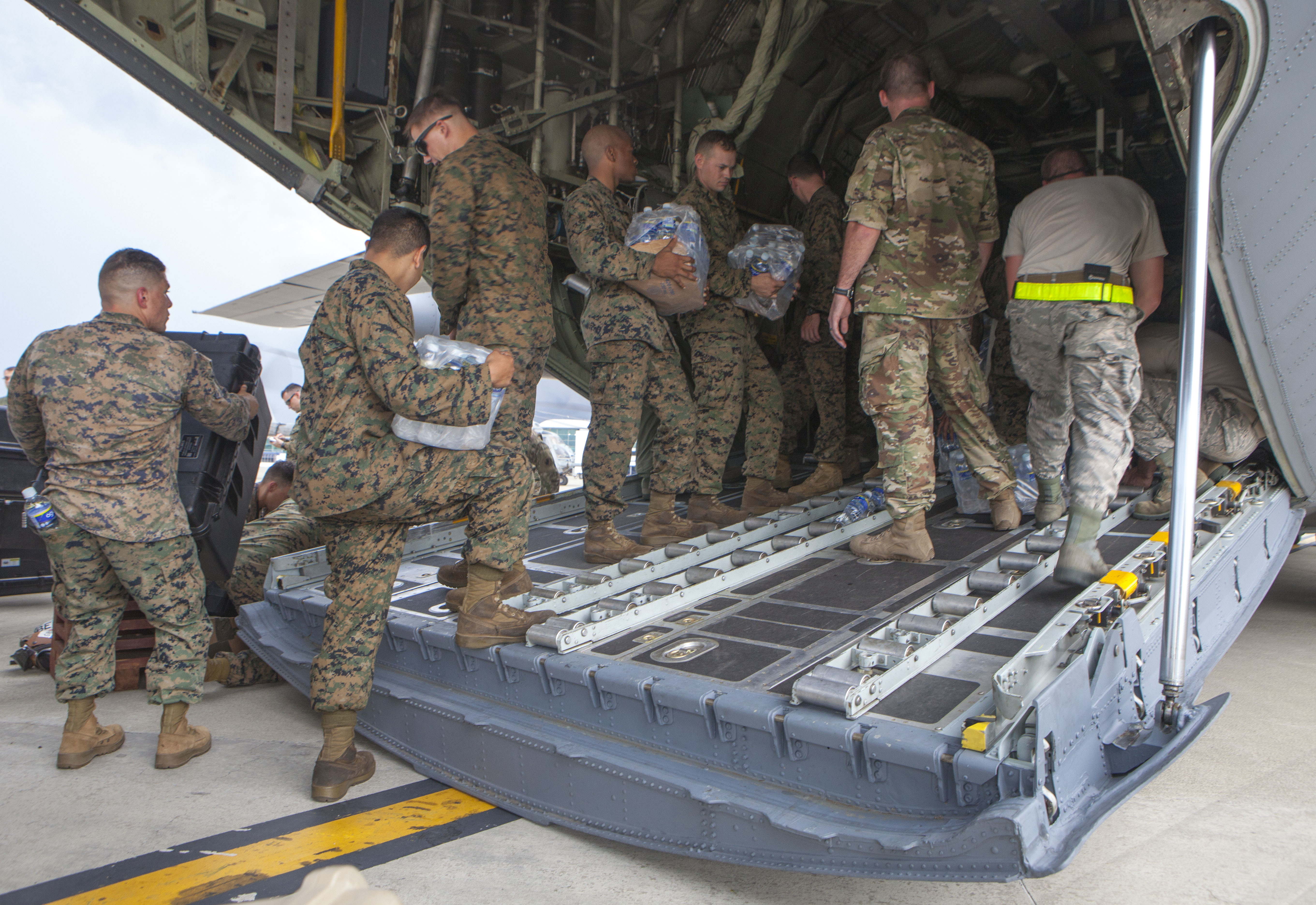 U.S. Marines with Special Purpose Marine Air-Ground Task Force - Southern Command and soldiers from 1st Battalion, 228th Aviation Regiment load an Ohio Air National Guard C-130H Hercules in preparation to depart Kingston, Jamaica, for Port-au-Prince, Haiti, to support the humanitarian assistance and disaster relief effort in response to Hurricane Matthew, Oct. 5, 2016. US Marine Corps photo.