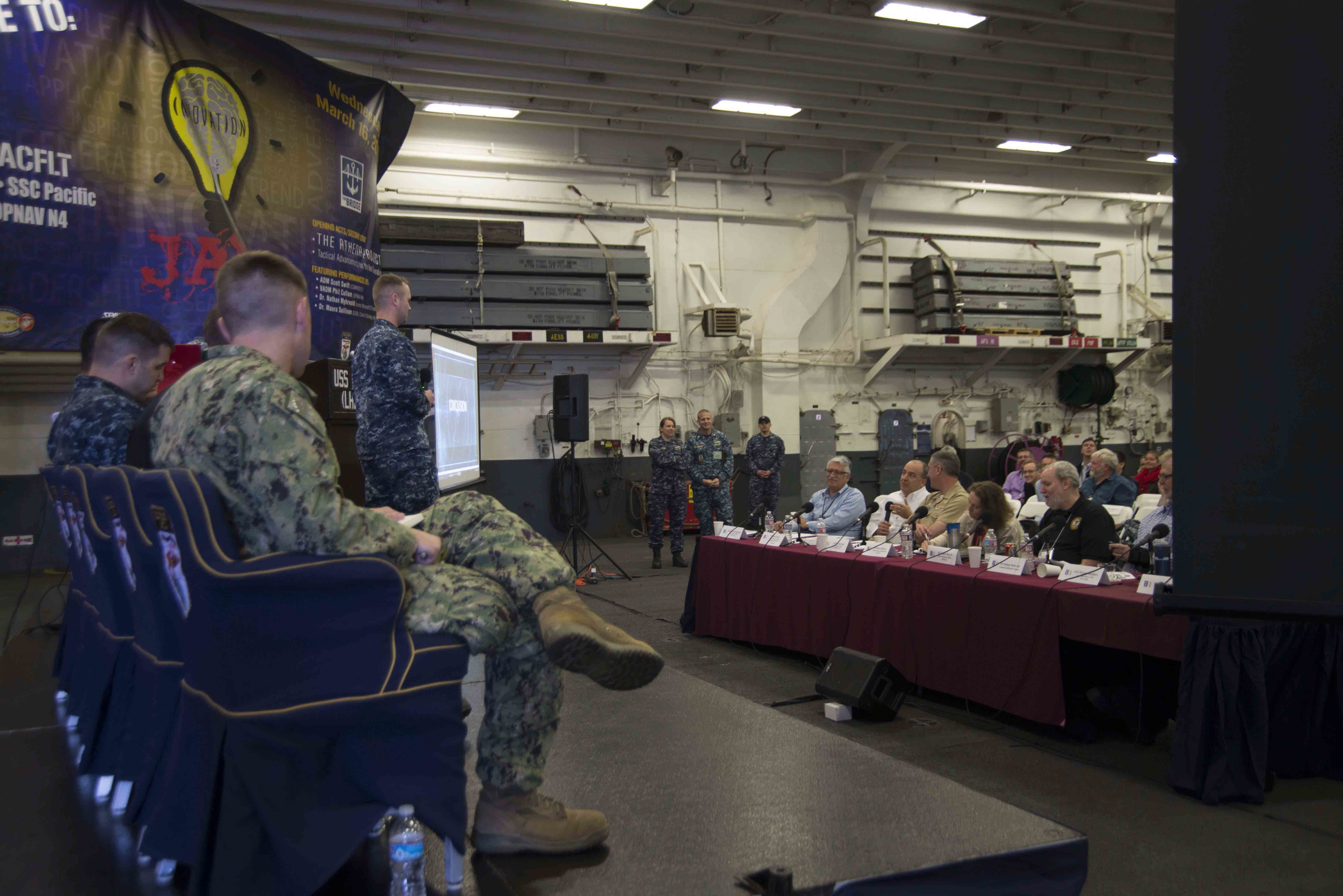 Lt. j.g. Rob McClenning answers questions from panel members about his new product pitch at the March 2016 Innovation Jam hosted aboard Wasp-class amphibious assault ship USS Essex (LHD 2). The Innovation Jam showcase pioneering concepts and rapid solutions to the fleet by SSC Pacific, the Athena Project, Tactical Advancements for the Next Generation and the Hatch. US Navy photo.
