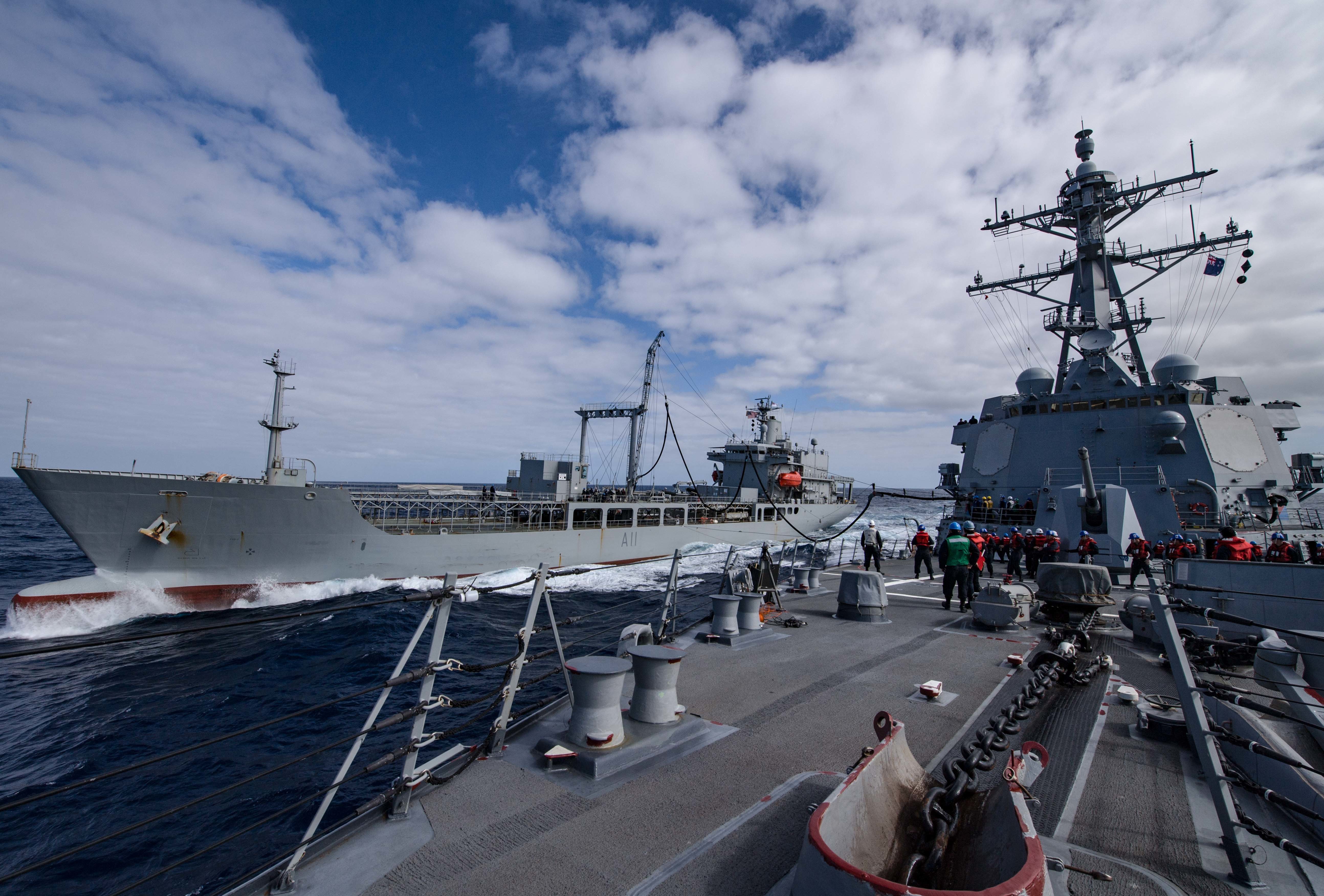 Arleigh Burke-class guided-missile destroyer USS Sampson (DDG 102), right, conducts a replenishment-at-sea with Her Majesty’s New Zealand Ship Endeavour (A11). Sampson will report to U.S. Third Fleet, headquartered in San Diego, while deployed to the Western Pacific as part of the U.S. Pacific Fleet-led initiative to extend the command and control functions of Third Fleet into the region.The destroyer's stop at a New Zealand port would be the first for a U.S. warship in more than 30 years. US Navy photo.