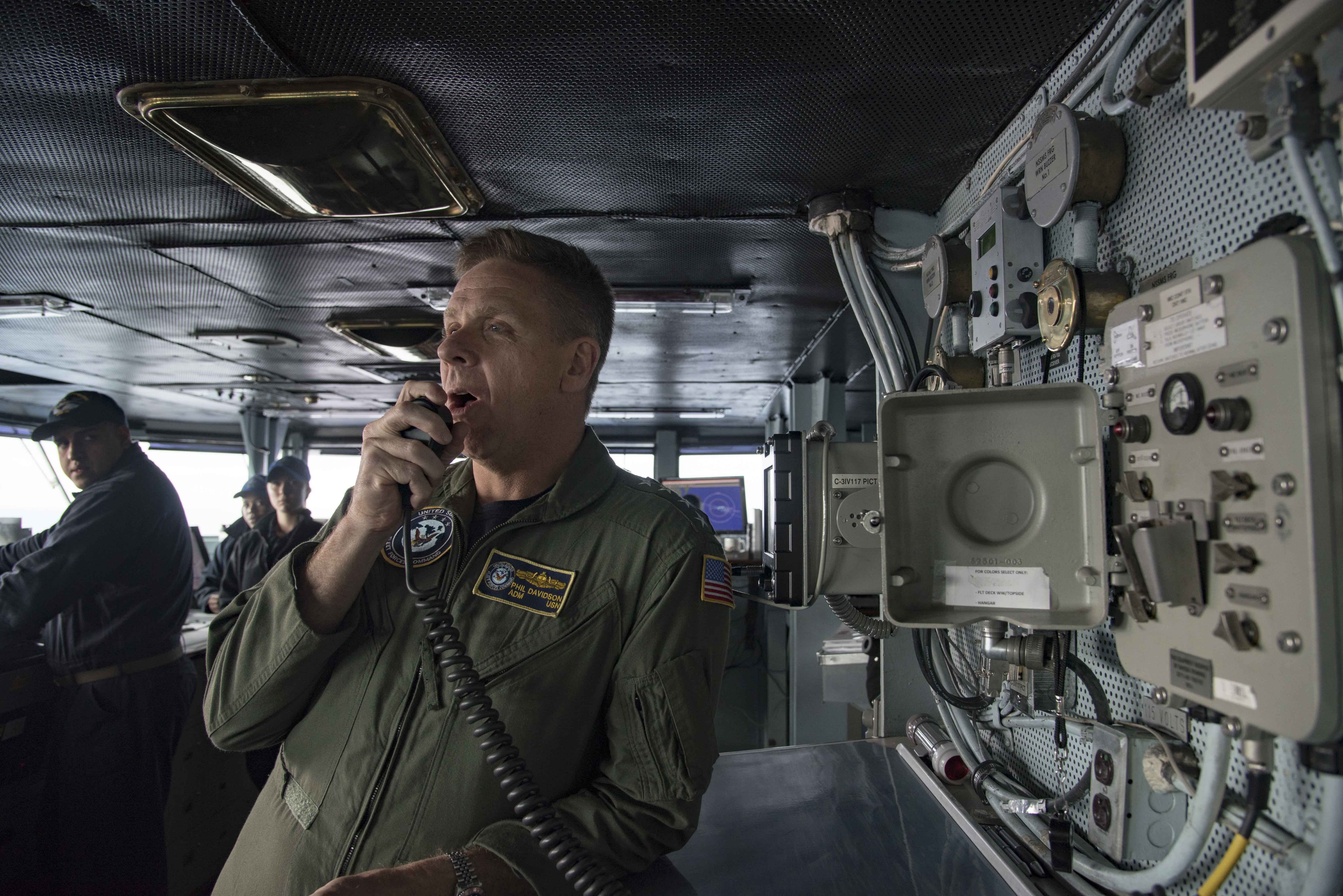 Adm. Phil Davidson, commander, U.S. Fleet Forces, addresses the crew of the aircraft carrier USS Dwight D. Eisenhower (CVN 69) (Ike) on Dec. 29, 2016, using the 1MC on the navigational bridge. Ike and its carrier strike group are returning from a 7-month combat deployment to the U.S. 5th and 6th Fleet areas of operation in support of Operation Inherent Resolve, maritime security operations and theater security cooperation efforts. US Navy photo. 