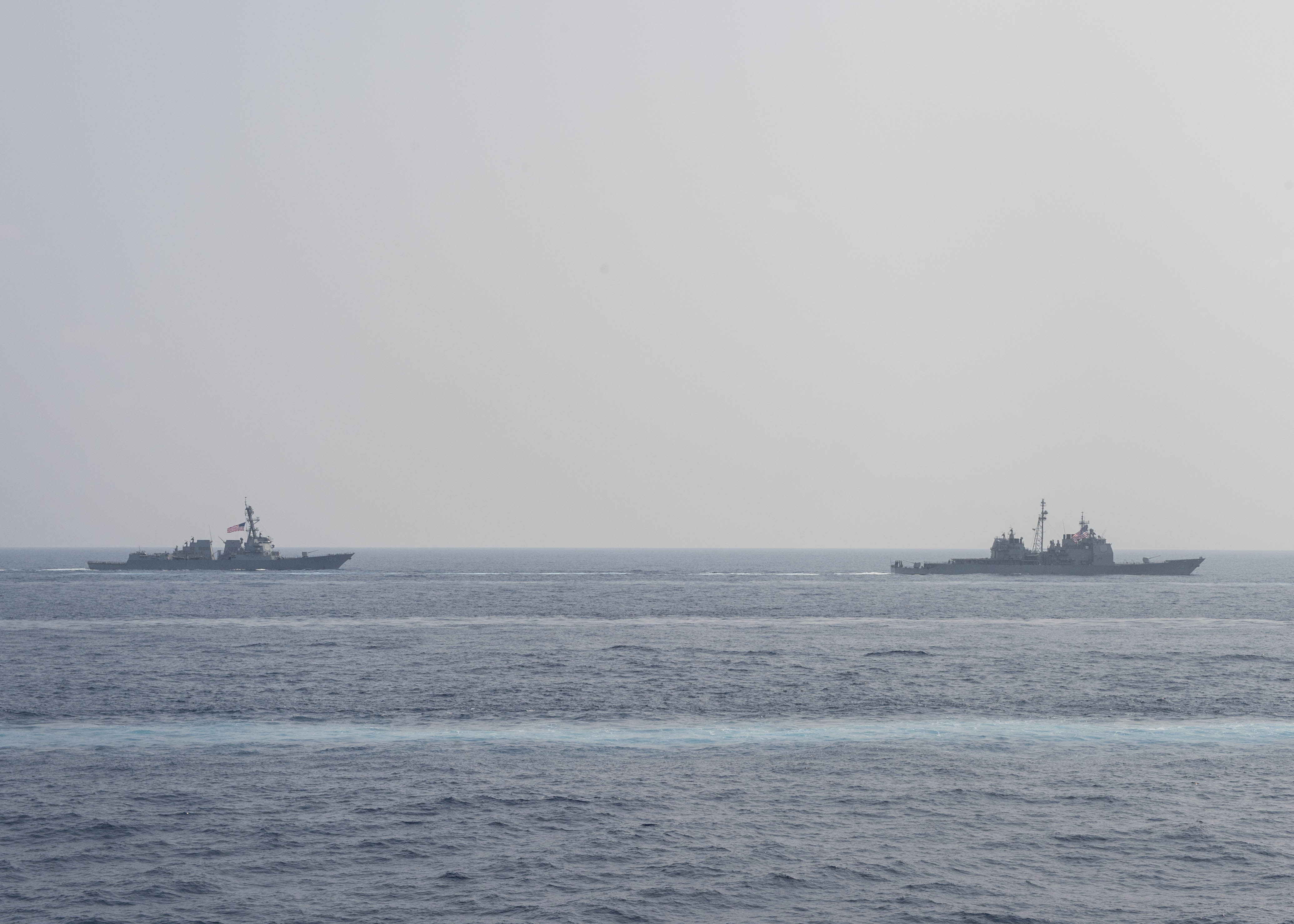 The guided-missile cruiser USS Mobile Bay (CG 53), right, and the guided-missile destroyer USS Stockdale (DDG 106) transit together in the Philippine Sea in March 2016. US Navy photo.