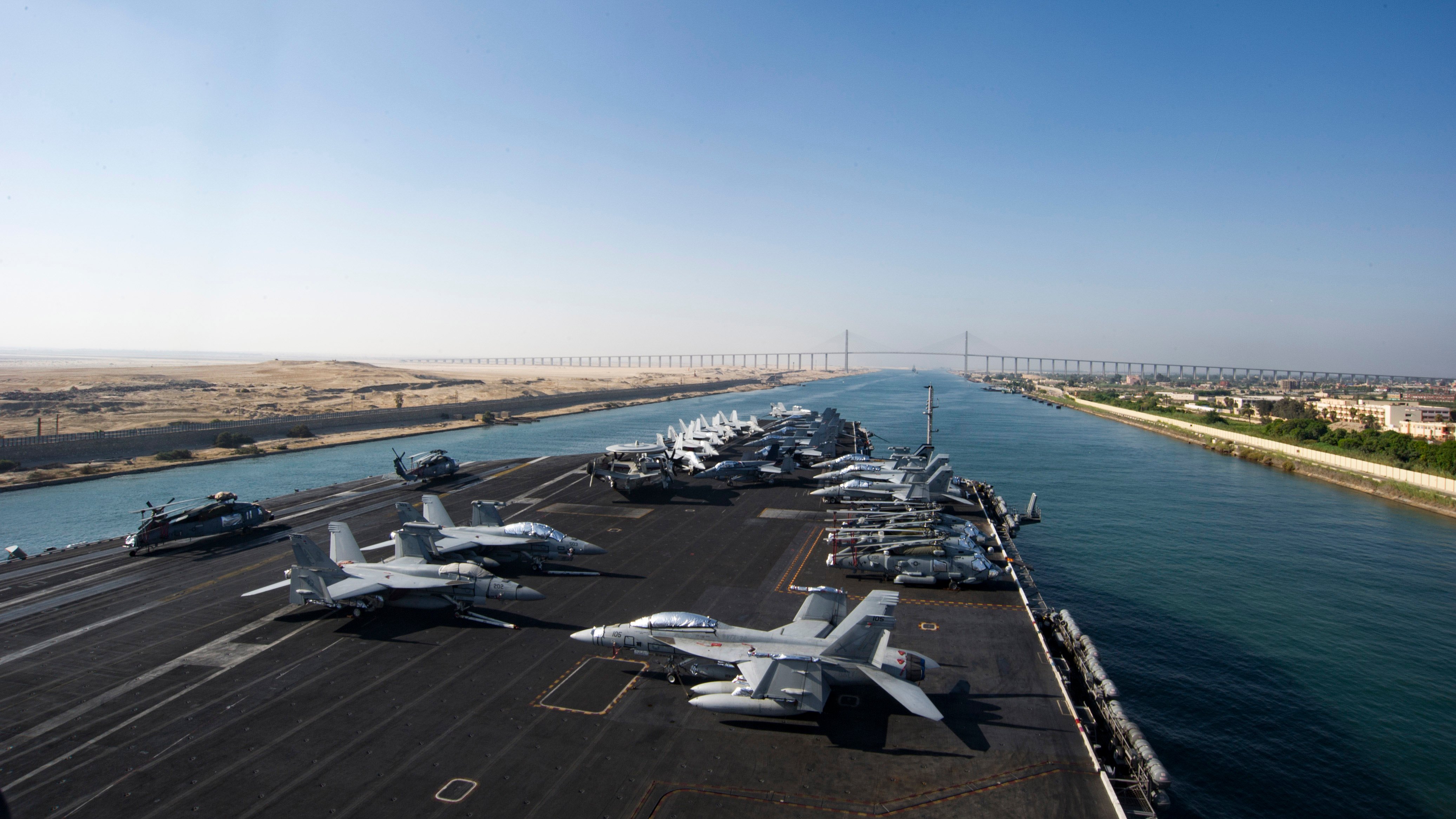 The aircraft carrier USS Dwight D. Eisenhower (CVN 69) approaches the Friendship Bridge as it transits the Suez Canal on July 8, 2016. The Eisenhower Carrier Strike Group was deployed in support of maritime security operations and theater security cooperation efforts in the U.S. 5th and 6th Fleet area of operations. US Navy photo.