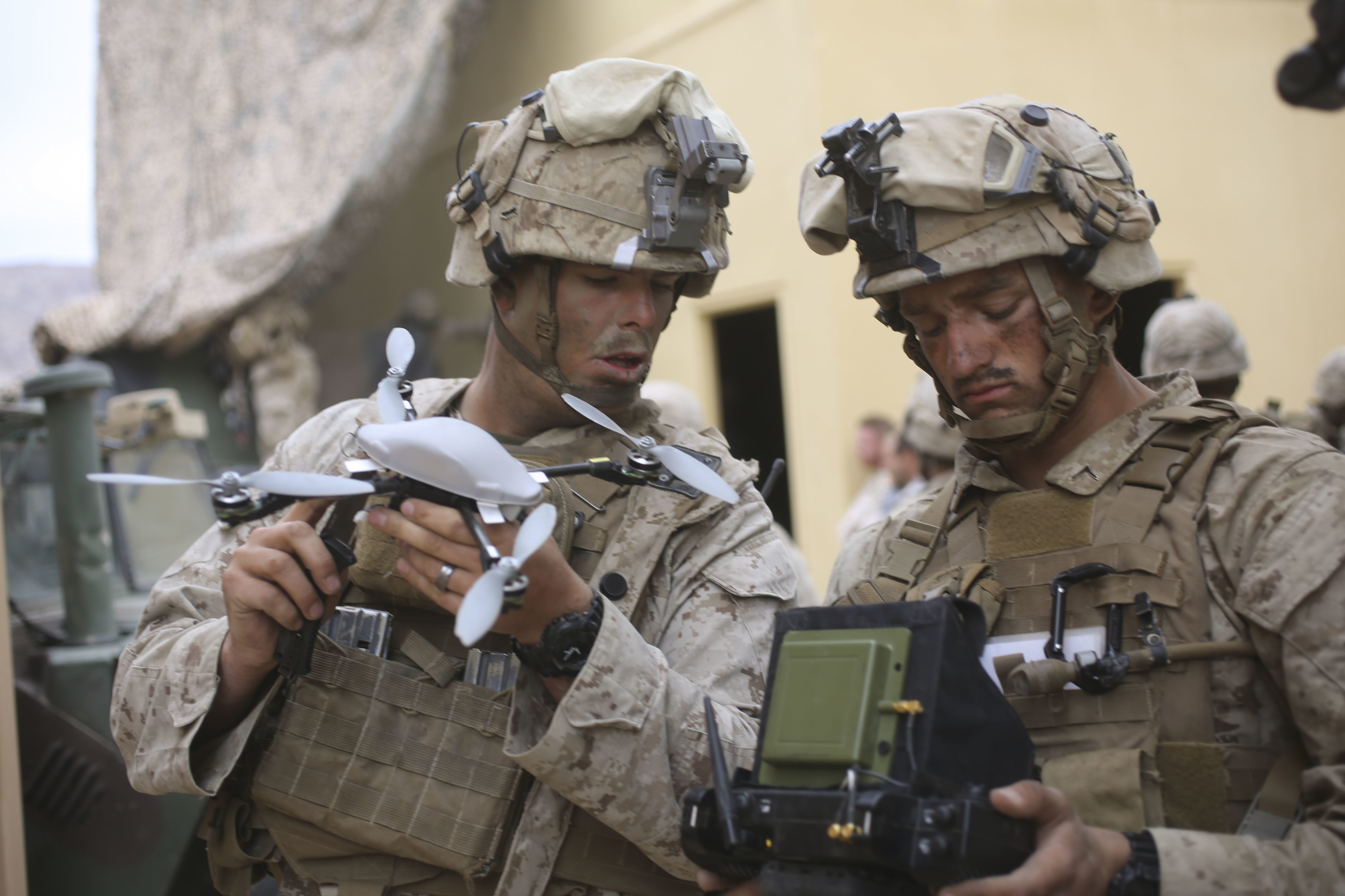 United States Marine Corps Private First Class Julius Lucio (left) and Sergeant Scott Phillips (right), 3rd Battalion, 5th Marine Regiment, India Company, perform last minute checks before taking an Instant-Eye unmanned aerial vehicle on patrol in Marine Corps Air Ground Combat Center 29 Palms, Calif. Oct 23, 2016. USMC Photo