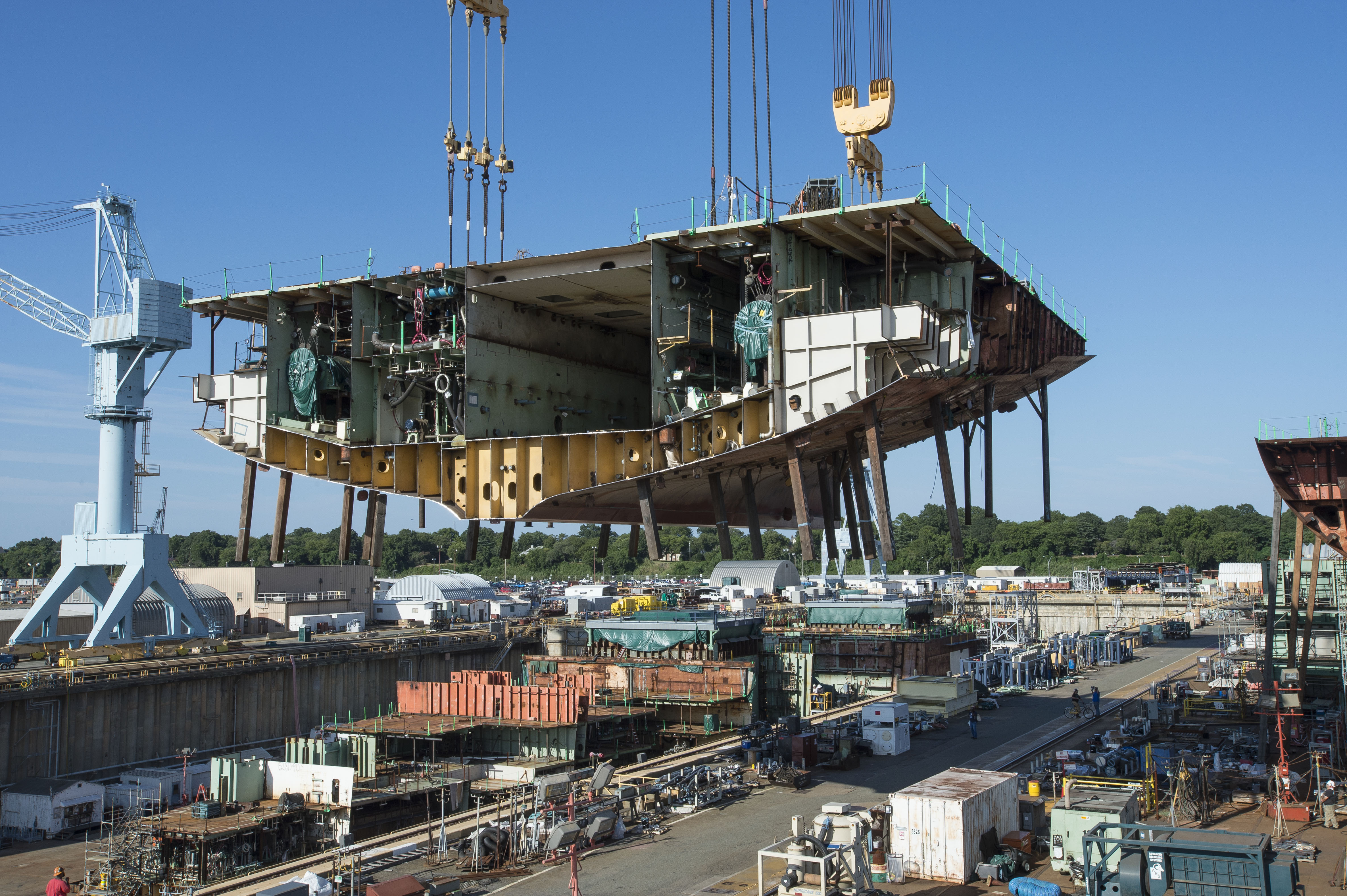 Newport News Shipbuilding placed a 900-ton superlift into dry dock, continuing construction of the nuclear-powered aircraft carrier John F. Kennedy (CVN 79). Nearly 90 lifts have been placed in the dock and joined together since the ship’s keel was laid in August 2015. Newport News Shipbuilding photo.