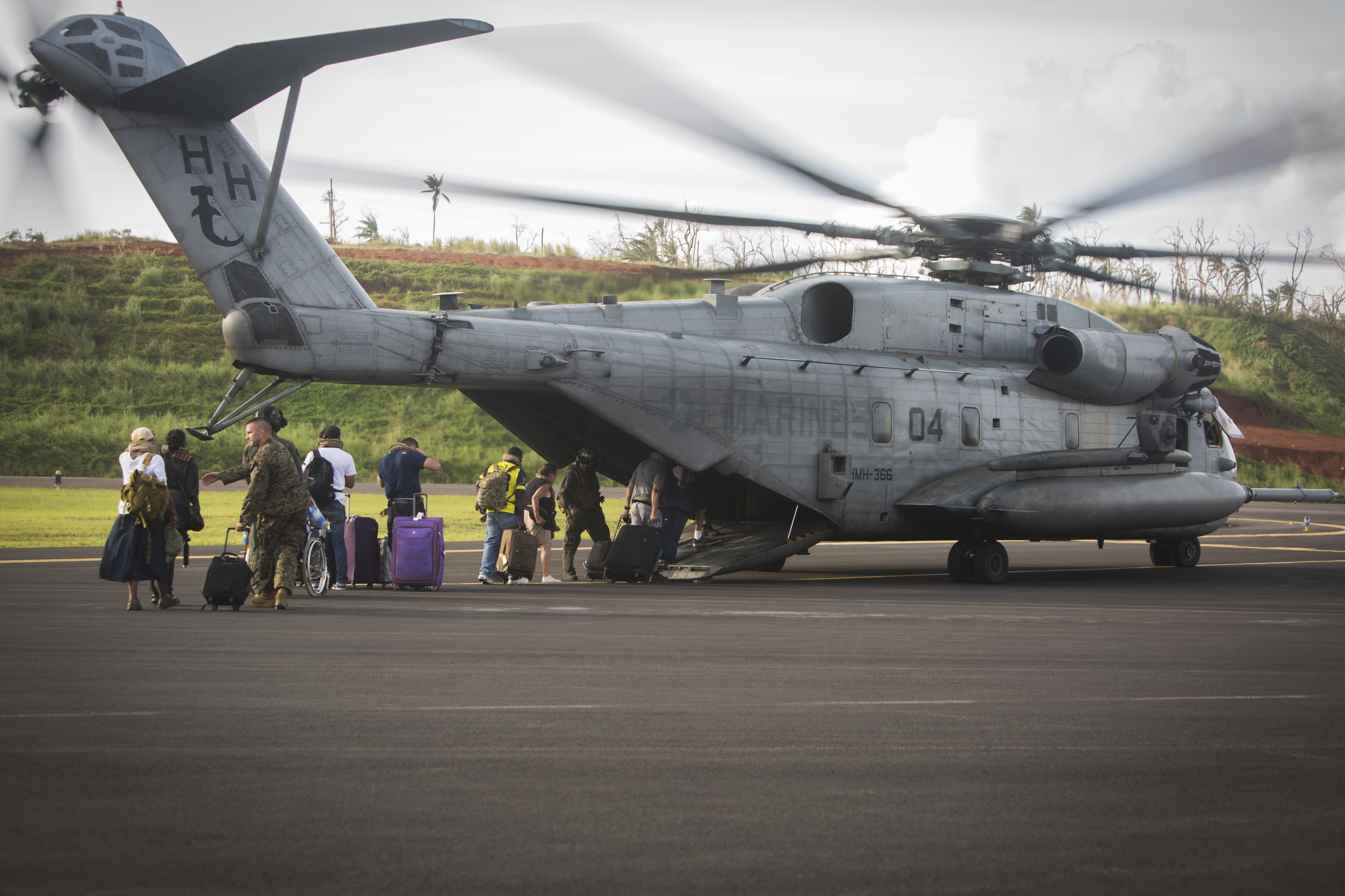 US citizens board a US Marine Corps CH-53E Super Stallion helicopter assigned to Joint Task Force - Leeward Islands (JTF-LI) at Douglas-Charles Airport in Dominica on Sept. 24, 2017. US Marine Corps Photo