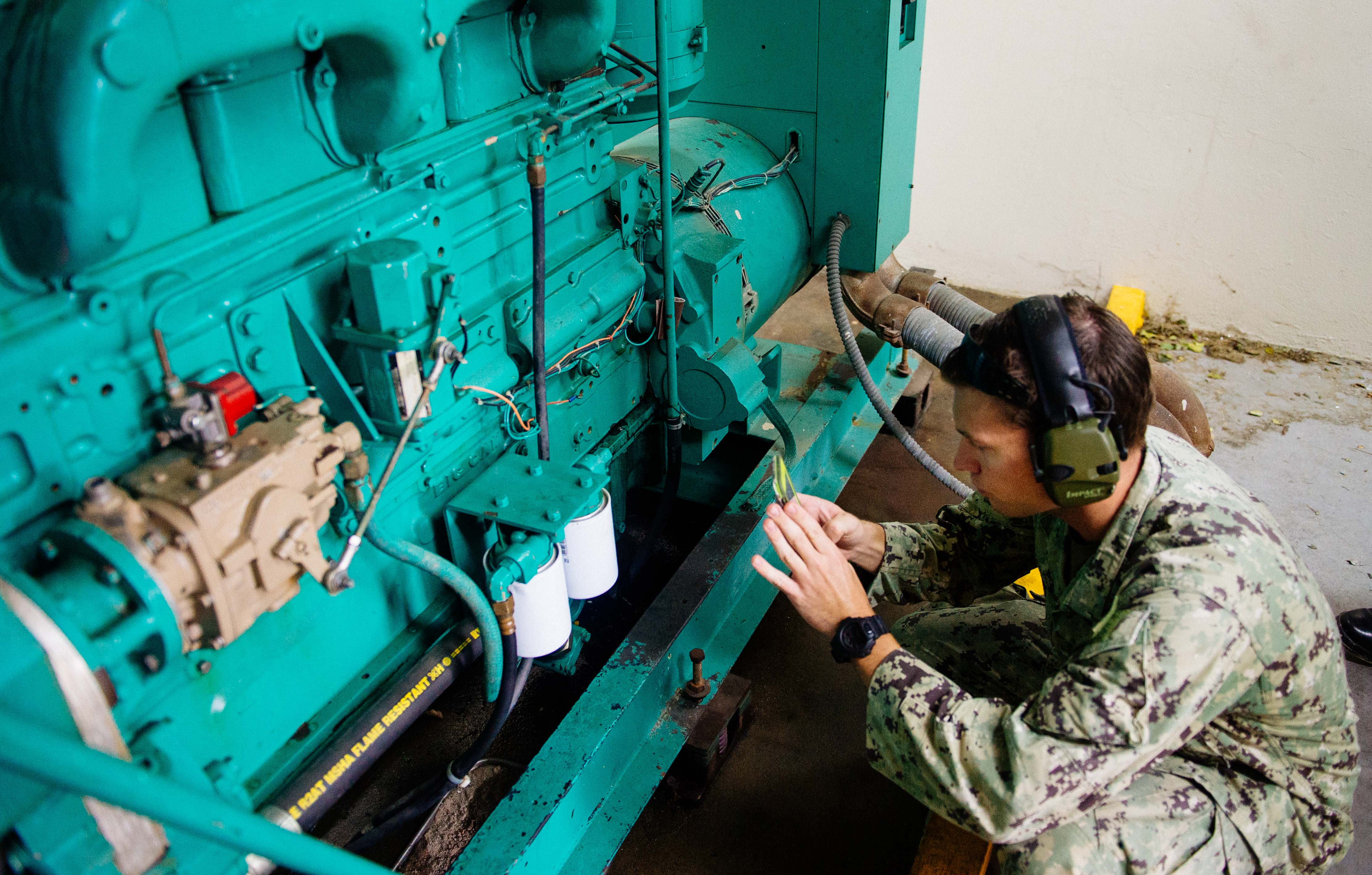 Construction Electrician 3rd Class Joshua Reding, assigned to Construction Battalion Maintenance Unit 202, inspects a generator at the Metropolitano De La Montana Hospital in Puerto Rico on Sept. 26 2017. US Navy