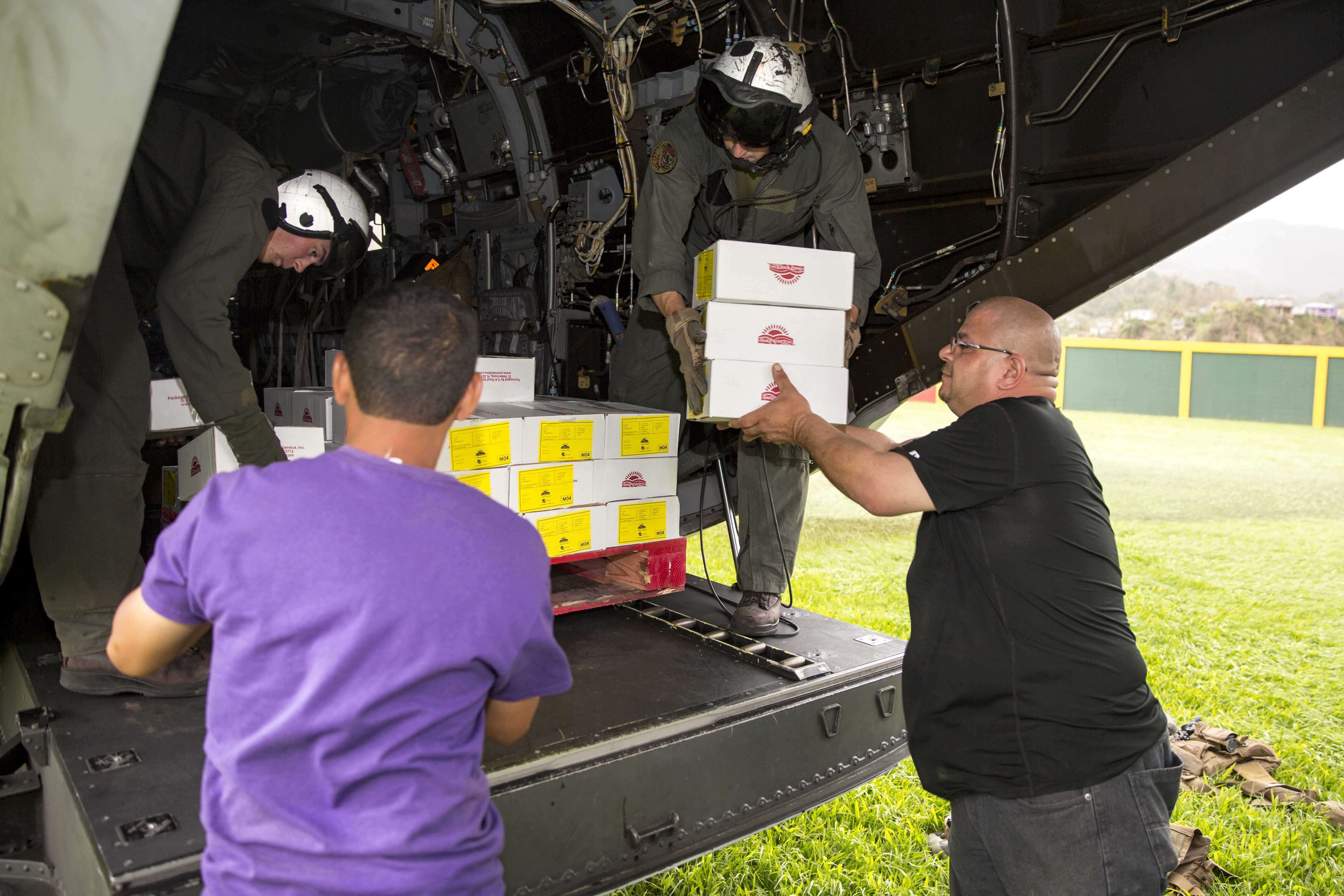 170927-N-KW492-251 JAYUYA, Puerto Rico (Sept. 27, 2017) Marines assigned to Marine Medium Tiltrotor Squadron (VMM) 162, embarked aboard the amphibious assault ship USS Kearsarge (LHD-3), and local volunteers unload food from an MV-22 Osprey in Jayuya, Puerto Rico for Hurricane Maria relief. (U.S. Navy photo )